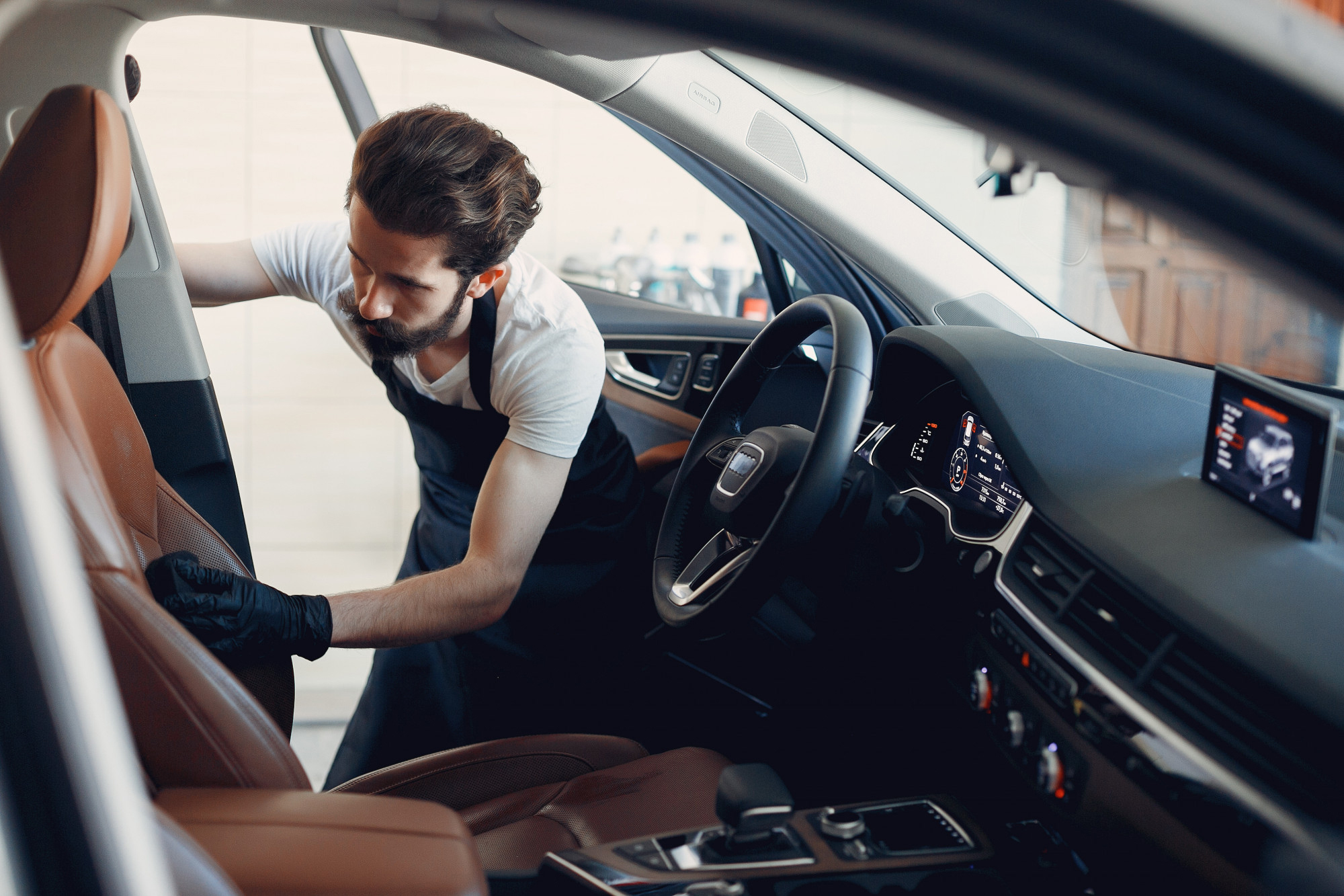 Premium Car Hub technician restoring luxury leather car upholstery in Dubai